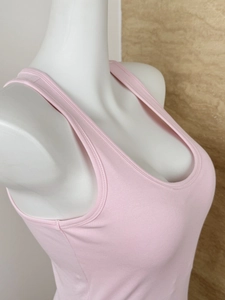 Detail view of pink sports camisole neck lining and armhole stitching on mannequin