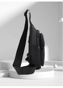 Detail of waterproof matte black men chest bag with multi-layer zipper compartments