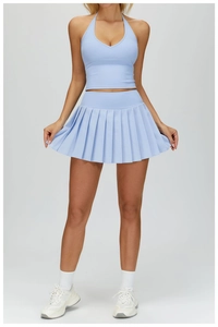 Detail of light blue pleated tennis skirt and halter neck top for fitness and running