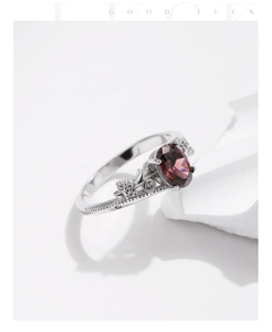 Macro detail of s925 silver vintage ring with oval purple gemstone and ornate engraving