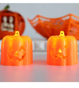Close-up of orange Halloween pumpkin LED night lights with glowing demon face expressions