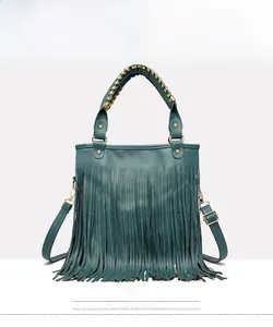 Detailed front view of teal fringe handbag with woven metal handle and gold hardware