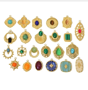 Macro view of assorted 18k gold plated stainless steel pendants with natural gemstones