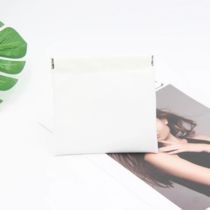 Close-up of white minimalist PU leather storage pouch with a metal squeeze closure