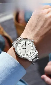 Close-up of business quartz watch with white Clous de Paris dial and Roman numerals