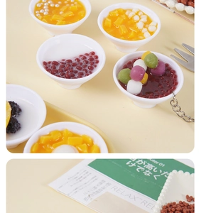 Detailed macro view of miniature mango pudding and dessert bowl food model keychain