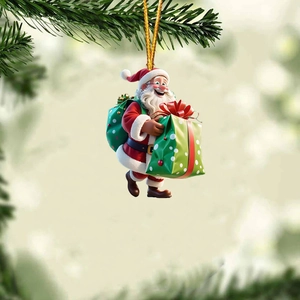 Close-up of a 3D cartoon Santa Claus acrylic ornament hanging on a green Christmas tree