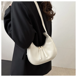 Detail of off-white crescent underarm bag with smooth PU leather and dual metal zippers