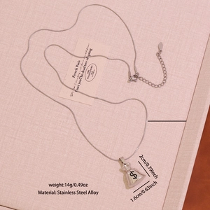 Detail view of money bag pendant with dollar sign on stainless steel alloy snake chain