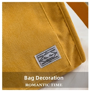 Detailed macro view of yellow corduroy fabric texture and vintage white cloth label