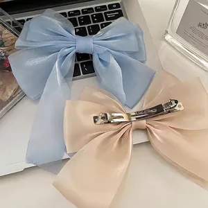 Elegant oversized light blue organza and champagne satin bow hair clips for women
