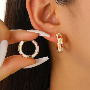 Vintage hoop earrings with white enamel red flowers and gold scrollwork details