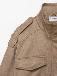 Detail of tan faux suede jacket showing lapel collar, epaulettes, and textured fabric