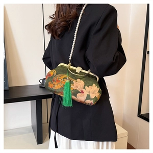 Detail of green floral brocade kiss-lock handbag with pearl chain and long silk tassel