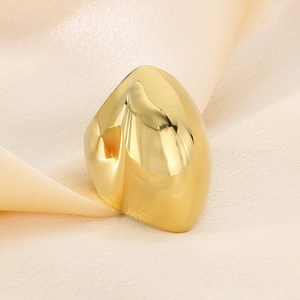 Detailed close-up of golden stainless steel ring on elegant draped silk fabric