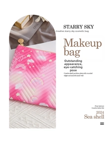 Detail of pink makeup bag featuring V-shaped quilting and gold star pattern charms