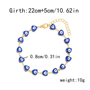 Detail view of gold heart devil eye anklet with size specs on white background