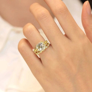 Close-up of luxury gold wedding ring set featuring a large square-cut center stone