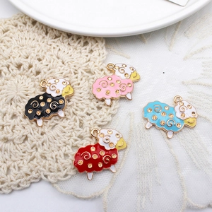 Cute sheep alloy charms in four colors for DIY jewelry making on a lace background