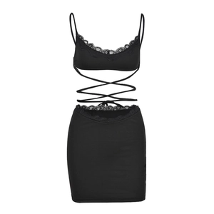 Close-up of black lace two-piece set featuring cross-strap top and bodycon skirt