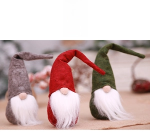 Detailed view of three Christmas gnomes in grey, red, and green with pointed felt hats