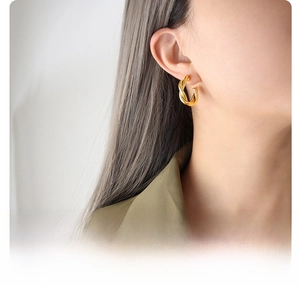 Detail of 18K gold plated surgical titanium steel C-shaped twisted knot earrings for women