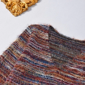 Close-up of multicolor knit top featuring V-neck and thick brushed yarn texture