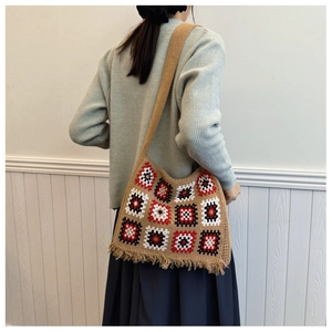 Detail of crochet tote bag featuring colorful geometric squares and fringe tassels