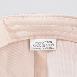 Detail shot of the cotton baseball cap inner lining and 100% cotton washing label
