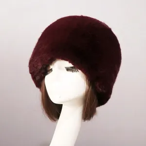 Close-up of deep red faux fur Russian style hat with thick fluffy texture on a mannequin