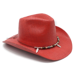 Detail showing the red woven straw texture and silver feather charms on the cowboy hat