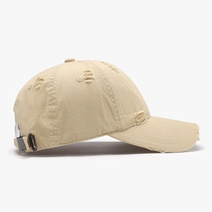 Distressed khaki cotton baseball cap with vintage frayed holes and adjustable metal buckle