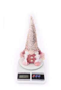 Pink sequin Christmas gnome plush figure on an electronic scale showing 149.8g weight
