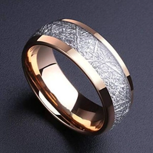 Macro shot of rose gold edges and grey meteorite-patterned inlay on industrial ring