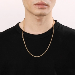 Golden twisted rope chain necklace shown on a model against a white background