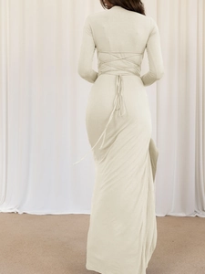 Chic beige Y2K long sleeve maxi dress featuring an elegant backless cross strap design