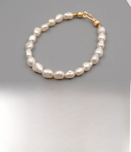Detailed view of handmade baroque freshwater pearl bracelet with golden copper clasp closure