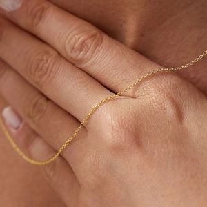 Detailed close-up of a minimalist 14K gold plated stainless steel thin link chain