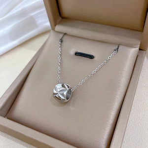 Detailed view of silver cylinder bead necklace in a luxury velvet jewelry gift box