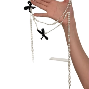 French vintage layered pearl necklace with black glitter bows and elegant long strand style