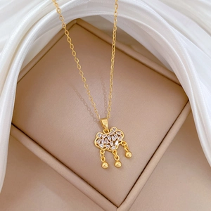 Macro view of gold titanium steel necklace with sparkling crystal cloud lock pendant