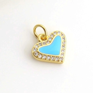 Detail view of heart pendant with blue enamel and sparkling cubic zirconia halo