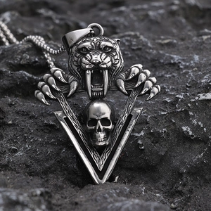Gothic stainless steel tiger head and skull pendant necklace on volcanic rock