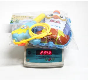 Detailed view of penguin backpack water gun set showing 235.6g weight on a digital scale