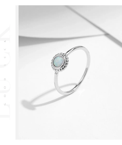 Detail of s925 silver sunflower ring featuring a round opal stone on white background