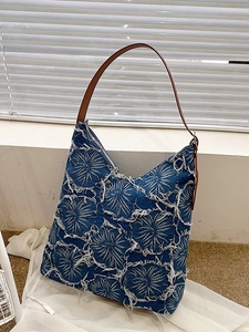 Vintage blue denim tote bag with white frayed circle pattern and brown leather strap