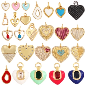 Various colorful heart shaped pendants in gold plated copper with enamel and zircon stones