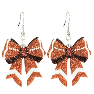 Glittery orange and brown football bow earrings with white stitching and silver hooks