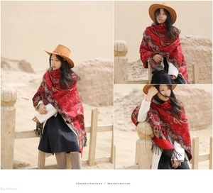 Close-up of ethnic red cashmere shawl with detailed bohemian prints and fringe