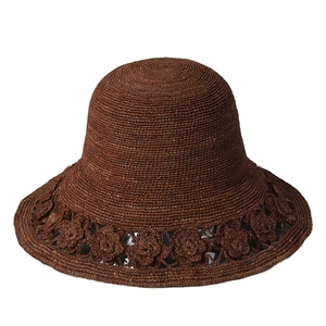 Handmade brown raffia sun hat with floral hollow lace design for summer travel